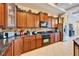 Spacious kitchen with granite countertops, stainless appliances and wood cabinets at 2903 Marble Crest Dr, Land O Lakes, FL 34638