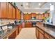 Open kitchen features granite counters, stainless steel appliances, and tiled floor at 2903 Marble Crest Dr, Land O Lakes, FL 34638