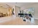 Open living room with tile flooring, grand piano, and access to patio at 2903 Marble Crest Dr, Land O Lakes, FL 34638