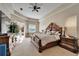 Spacious main bedroom with natural light, a decorative bed frame, and a view of the pool at 2903 Marble Crest Dr, Land O Lakes, FL 34638