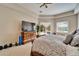 Light-filled main bedroom showcasing a pool view and entertainment center with a large TV at 2903 Marble Crest Dr, Land O Lakes, FL 34638