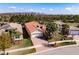 An aerial view of this beautiful house, with lush green surroundings, a brick driveway, and a barrel tile roof at 4822 Grand Banks Dr, Wimauma, FL 33598