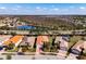 Aerial view of the property featuring a barrel tile roof, a pond in the backyard, and mature trees at 4822 Grand Banks Dr, Wimauma, FL 33598