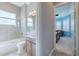 Bright bathroom features modern fixtures, tiled shower, and a spacious vanity at 4822 Grand Banks Dr, Wimauma, FL 33598