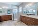 Elegant bathroom featuring double sinks, modern fixtures, and a glass-enclosed shower for a spa-like experience at 4822 Grand Banks Dr, Wimauma, FL 33598
