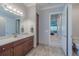 Bathroom features updated vanity, large mirror and access to bedroom at 4822 Grand Banks Dr, Wimauma, FL 33598