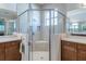 Elegant walk-in shower with modern fixtures, tiled walls, and a glass enclosure at 4822 Grand Banks Dr, Wimauma, FL 33598