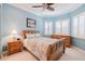 Comfortable bedroom with a ceiling fan, shutters, and neutral decor for relaxation at 4822 Grand Banks Dr, Wimauma, FL 33598