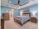Comfortable bedroom with blue walls, plantation shutters, and a ceiling fan creating a relaxing atmosphere at 4822 Grand Banks Dr, Wimauma, FL 33598