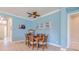 Inviting dining area with a wooden table, comfortable seating, and bright blue walls at 4822 Grand Banks Dr, Wimauma, FL 33598