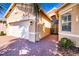 Exterior of a charming single Gathering home featuring a two car garage, a brick driveway and mature landscaping at 4822 Grand Banks Dr, Wimauma, FL 33598
