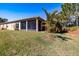 Landscaped backyard showing screened-in lanai with brick floor and exterior at 4822 Grand Banks Dr, Wimauma, FL 33598