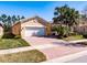 Charming single-story home with a paved driveway and attached two-car garage at 4822 Grand Banks Dr, Wimauma, FL 33598