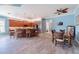 Spacious kitchen and dining area featuring a central island, dark wood cabinets, and tiled floors at 4822 Grand Banks Dr, Wimauma, FL 33598