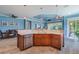 Kitchen island featuring seating and a dishwasher is open to the living and dining spaces at 4822 Grand Banks Dr, Wimauma, FL 33598