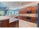 Well-lit kitchen area features custom wood cabinetry, granite countertops, and stainless steel appliances at 4822 Grand Banks Dr, Wimauma, FL 33598