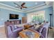 Spacious living room with a tray ceiling and access to the outdoor patio and garden at 4822 Grand Banks Dr, Wimauma, FL 33598