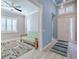 Open-concept area features tiled floors, a comfortable couch, and a bright entry at 4822 Grand Banks Dr, Wimauma, FL 33598