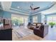 Relaxing living room with ample seating and a view of the backyard through large glass windows at 4822 Grand Banks Dr, Wimauma, FL 33598