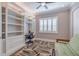 Well-lit home office with built-in shelving, desk space, and window shutters at 4822 Grand Banks Dr, Wimauma, FL 33598