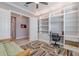 Office area showcasing built-in shelving, desk, and cozy seating at 4822 Grand Banks Dr, Wimauma, FL 33598