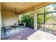 Relax on this screened-in brick patio with a ceiling fan and views of lush greenery at 4822 Grand Banks Dr, Wimauma, FL 33598