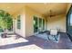 Enjoy the outdoors in this covered patio with brick flooring and comfortable seating area at 4822 Grand Banks Dr, Wimauma, FL 33598