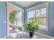 Sunroom with large windows brings the outdoors in, creating a bright and airy living space at 4822 Grand Banks Dr, Wimauma, FL 33598