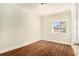 Empty bedroom featuring wood floors and natural light at 505 E Cluster Ave, Tampa, FL 33604