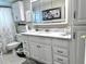 Bright bathroom with a white vanity, marble countertop, and a decorative mirror cabinet at 5108 Brittany S Dr # 204, St Petersburg, FL 33715