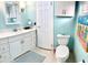 Charming bathroom featuring a toilet with starfish decorations and aqua-painted walls at 5108 Brittany S Dr # 204, St Petersburg, FL 33715