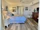 Relaxing bedroom enhanced by wood-look floors and coastal-themed decor at 5108 Brittany S Dr # 204, St Petersburg, FL 33715