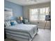Comfortable bedroom with blue and white striped bedding, a beach-themed chair, and waterfront artwork at 5108 Brittany S Dr # 204, St Petersburg, FL 33715