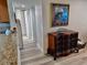 Hallway featuring wood-look floors, a decorative chest, and a glimpse into other parts of the home at 5108 Brittany S Dr # 204, St Petersburg, FL 33715