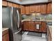 Updated kitchen featuring granite countertops, stainless steel appliances, wood cabinets, and tile backsplash at 5108 Brittany S Dr # 204, St Petersburg, FL 33715