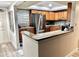 Updated kitchen with stainless steel appliances, wood cabinets, granite counters, and an eat-in bar at 5108 Brittany S Dr # 204, St Petersburg, FL 33715