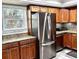 Updated kitchen featuring granite countertops, stainless steel appliances, wood cabinets, and tile backsplash at 5108 Brittany S Dr # 204, St Petersburg, FL 33715