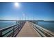 Scenic view down a wooden pier extending into the tranquil, sunlit water at 5108 Brittany S Dr # 204, St Petersburg, FL 33715