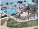 Resort-style pool area with palm trees, lounge chairs, and water views near the beach at 5108 Brittany S Dr # 204, St Petersburg, FL 33715