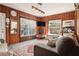 Comfortable living room featuring wood-paneled walls and natural light at 5808 N 16Th St, Tampa, FL 33610