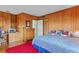 Wood paneled bedroom with desk and cabinet, hardwood flooring, and a red accent rug at 606 20Th Ne Ave, St Petersburg, FL 33704