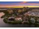 Waterfront home with pool, surrounded by lush landscape, coastal beauty and marina at 705 Riviera Dunes Way, Palmetto, FL 34221