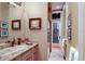Elegant bathroom featuring granite counters, decorative artwork, and access to the outdoors at 705 Riviera Dunes Way, Palmetto, FL 34221
