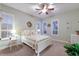 Serene bedroom with ample natural light, neutral decor, and ceiling fan at 705 Riviera Dunes Way, Palmetto, FL 34221