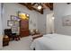 Bright bedroom boasts exposed beam ceiling, an ensuite bathroom and decorative furniture at 705 Riviera Dunes Way, Palmetto, FL 34221