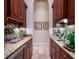 Stylish butler's pantry boasts rich wood cabinetry, granite counters, and wine storage at 705 Riviera Dunes Way, Palmetto, FL 34221