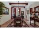 Elegant dining room with wood beams, decorative lighting, and tile flooring at 705 Riviera Dunes Way, Palmetto, FL 34221