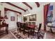 Formal dining room featuring exposed beams, chandelier, and elegant furnishings at 705 Riviera Dunes Way, Palmetto, FL 34221