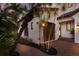 Charming home with a clay tile roof, textured stucco walls, and lush tropical landscaping at 705 Riviera Dunes Way, Palmetto, FL 34221