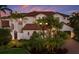 Mediterranean-style home with a red tile roof, tropical plants, and a private gated entrance at 705 Riviera Dunes Way, Palmetto, FL 34221